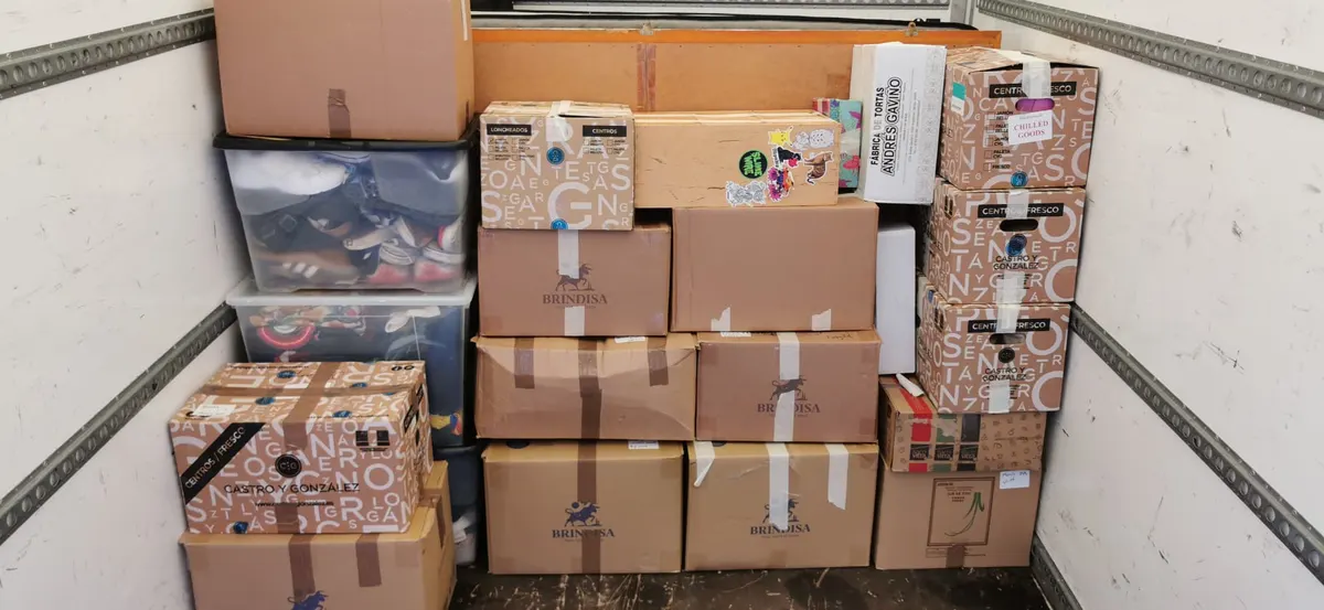 Cardboard boxes, plastic storage drawers and furniture panels loaded in a DNE van